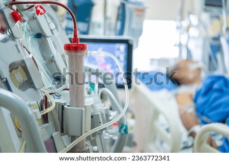 Experts are preparing a dialysis machine for use in critically ill patients in hospital intensive care units.