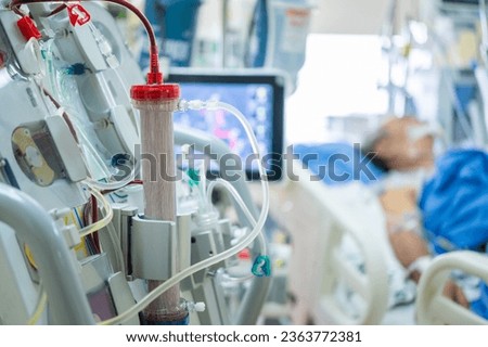 Experts are preparing a dialysis machine for use in critically ill patients in hospital intensive care units.
