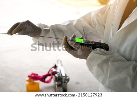 Experts are using instruments to measure climate in the environment.Measurement of air temperature and humidity using a digital hygrometer. Selective focus.
