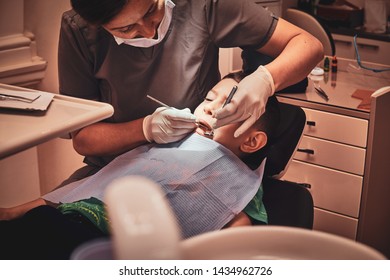 Expirienced Dentist Is Checkin Littles Scared Kid's Teeth At Her Proffecional Parlour.