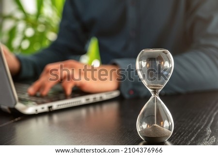 Expiring hourglass on a desk as a symbol of time pressure or expiring deadlines Stock foto © 