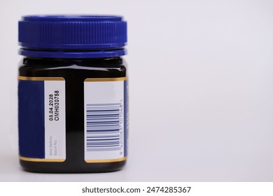 Expiry date, Batch No. and barcode information printed on side on product sticker attached to plastic bottle, isolated on white background