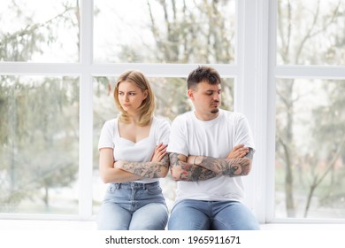 Explain It. Young Emotional Strict Man Feeling Jealous, Waiting For Explanations And Looking At His Wife Ignored Him While Closing Her Ears With Her Hands