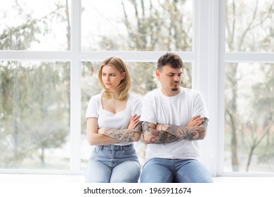 Explain It. Young Emotional Strict Man Feeling Jealous, Waiting For Explanations And Looking At His Wife Ignored Him While Closing Her Ears With Her Hands