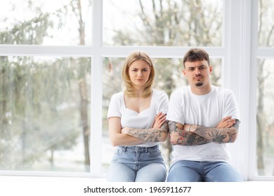 Explain It. Young Emotional Strict Man Feeling Jealous, Waiting For Explanations And Looking At His Wife Ignored Him While Closing Her Ears With Her Hands