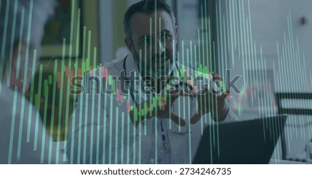 Explaining doctor in lab coat stethoscope gesturing at clinic desk with laptop and charts overlay. Clinician, patient, healthcare, consultation, visualization, candlestick, bargraph