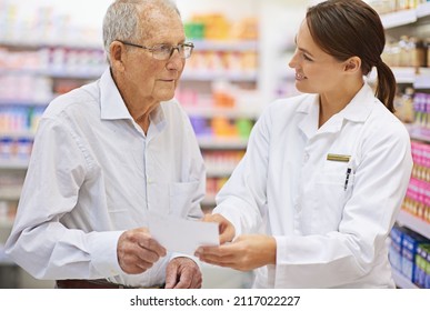 Explaining Prescriptions In Plain Language. Shot Of A Young Pharmacist Helping An Elderly Customer With His Prescription.