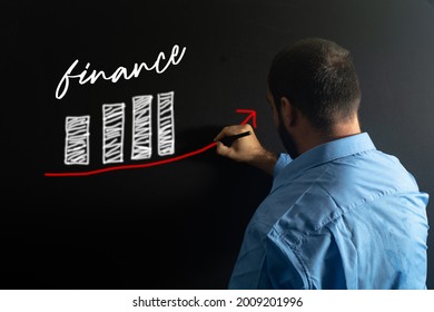 Explanation Of Finance Concept By Economics Professor. Teacher Writing On The Blackboard