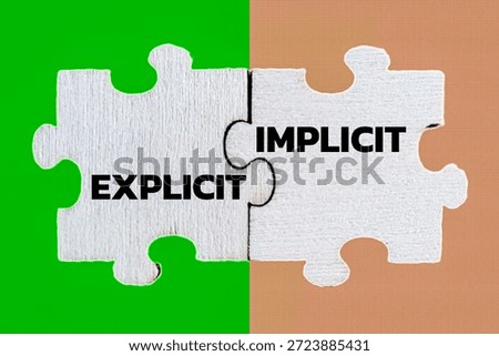 Explicit and Implicit Concepts Shown on Connected White Puzzle Pieces Over Split Green and Tan Background