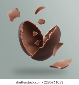 Exploded milk chocolate egg on grey background