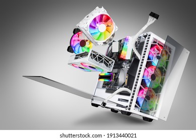 exploded view of white gaming pc computer with glass windows and rainbow rgb LED lights. Flying hardware components abstract technology concept on gray background