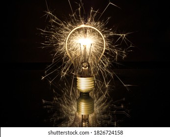 Exploding Lightbulb In Front Of Black Background