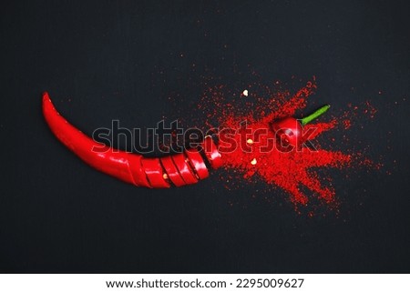 Exploding pepper. Chili pepper turns into powder. Dark background.
