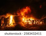 Exploding warehouse. Burning industrial building. Big blaze at night.