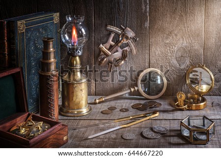 Exploration and nautical theme grunge background. Compass, telescope, sextant, coin, divider and old book on wood desk
