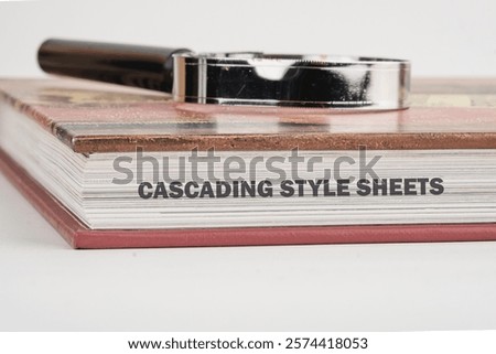 Exploration of the principles behind cascading style sheets is highlighted by a book and a magnifying glass, emphasizing the importance of this technology in web design.
