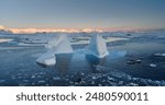 Explore Antarctica nature. Melting blue water iceberg float in icy ocean. Expeditions and adventures in Antarctica, tourist red boat, people discover the beauty of South Pole. Aerial drone flight