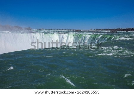 Explore the breathtaking beauty of Niagara Falls in Ontario, Canada, where the stunning waterfall creates a majestic landscape that captivates visitors year round