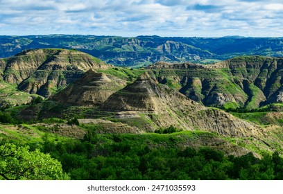 Explore the breathtaking natural beauty of the majestic green canyon landscape with rugged terrain, lush greenery, and stunning panoramic views, Little Missouri State Park, North Dakota - Powered by Shutterstock