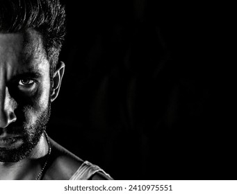 Explore the captivating interplay of light and shadow in this narrow black and white portrait. A 30-year-old man.