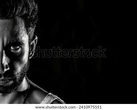 Explore the captivating interplay of light and shadow in this narrow black and white portrait. A 30-year-old man.