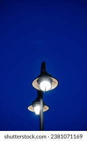 Explore the charm of urban nights with this captivating photo featuring a lone streetlight against a starlit sky. 