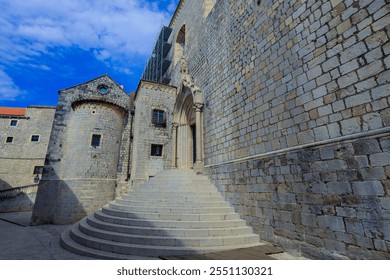 Explore the historic architecture and stone steps leading to a grand entrance in Dubrovnik Croatia under a bright blue sky - Powered by Shutterstock