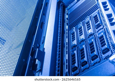 Explore the interior of a modern data center showcasing high-tech server racks illuminated by blue lights, emphasizing innovation and connectivity in computing technology.