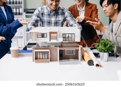 Explore a modern architectural office meeting with Asian professionals designing innovative buildings. รื นดดรแำ - Powered by Shutterstock