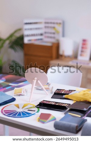 Explore personal color analysis with makeup palette color charts a mirror and fabric swatches on a fashion stylist desk Ideas for seasonal color beauty and style