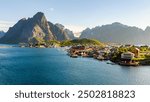 Explore the picturesque village of Reine in Norways Lofoten Islands, where majestic mountains and tranquil waters create an ideal backdrop for adventurers and nature lovers