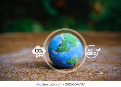 Explore a small world globe symbolizing CO2 reduction and net zero emissions by 2050. Embrace the icon of sustainability and join the journey towards a greener future.