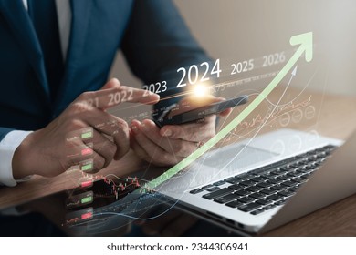 Explore the stock market trends for 2024 with analytical visuals of businessman planning long term investments and future business growth, Navigate towards success with smart strategies. - Shutterstock ID 2344306941
