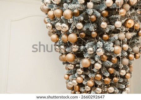 Explore the unique charm of this beautifully designed upsidedown Christmas tree, adorned with shimmering gold and silver ornaments, perfect for your holiday celebrations