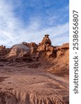 Explore the unique rock formations of Goblin Valley State Park in Utah, showcasing breathtaking views and earthy landscapes under a blue sky. Perfect for nature and geology enthusiasts.