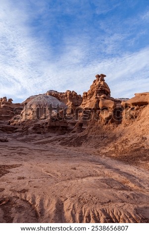 Explore the unique rock formations of Goblin Valley State Park in Utah, showcasing breathtaking views and earthy landscapes under a blue sky. Perfect for nature and geology enthusiasts.