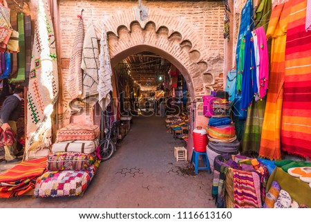  Explore the vibrant Marrakech market, featuring handmade rugs, colorful fabrics, and artisanal crafts set in a historic Medina alleyway. Perfect for cultural tourism and authentic shopping experience