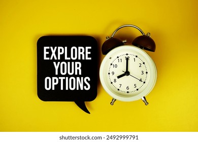 Explore Your Options text on speech bubble with alarm clock top view on yellow background