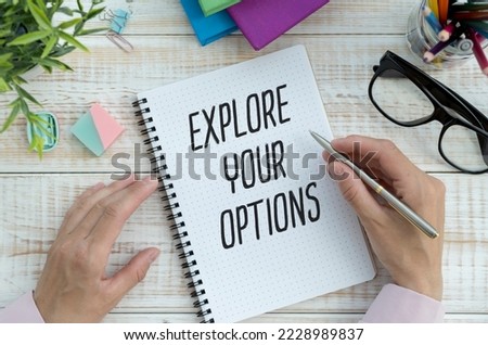 Explore Your Options write on sticky note isolated on Wooden Table.