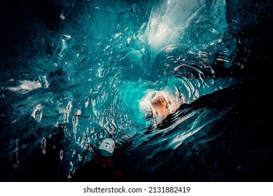 Explorer Going down Ice Cave in Iceland