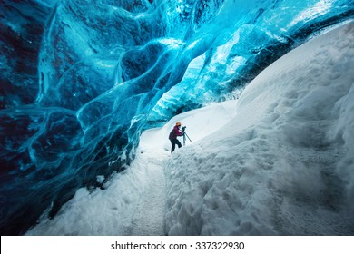 Explorer inside ice cave at Vatnajokull glacier, Iceland