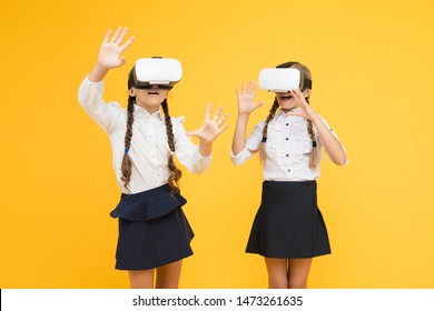 Exploring augmented reality. Experiences communicate and manage projects.Kids use modern VR technology. Virtual reality. VR headset. Future education. Children schoolgirls wear wireless VR glasses.