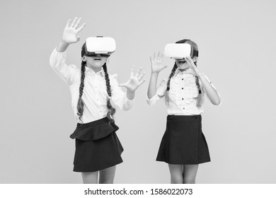 Exploring augmented reality. Experiences communicate and manage projects.Kids use modern VR technology. Virtual reality. VR headset. Future education. Children schoolgirls wear wireless VR glasses.