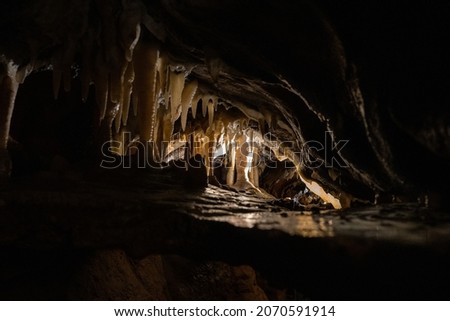 exploring dark underground caverns with stalagmites and stalactites