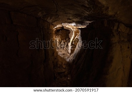exploring dark underground caverns with stalagmites and stalactites