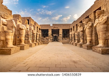 EXPLORING EGYPT - KARNAK TEMPLE - Large pharaoh sculptures inside beautiful Egyptian landmark with hieroglyphics, ancient symbols. Famous world civilization art near Nile River, Cairo and Luxor, Egypt