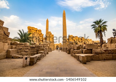 EXPLORING EGYPT - KARNAK TEMPLE - Travel tour group wanders through Karnak Temple. Beautiful Egyptian landmark with hieroglyphics, decayed temples, obelisks, towers, and other buildings. Luxor, Egypt