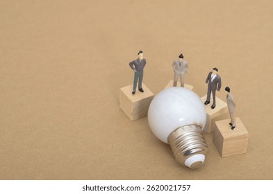 Exploring Ideas: Miniature Team Analyzing Light Bulb for Creative Solutions