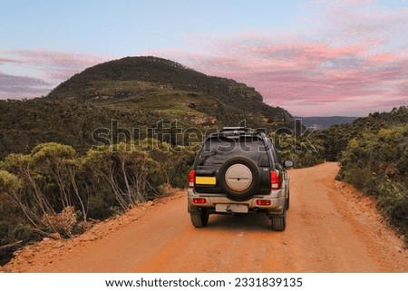 Exploring the magnificent Blue Mountains Australia. A four wheel drive 4WD traveling along a dirt track in the Blue Mountains