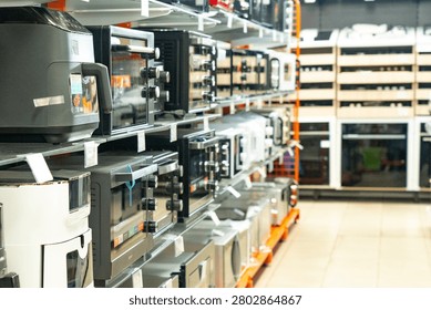 Exploring a Modern Display of Kitchen Appliances: A Visual Guide to the Latest Ovens, Microwaves, and Cooking Equipment in a Retail Setting
